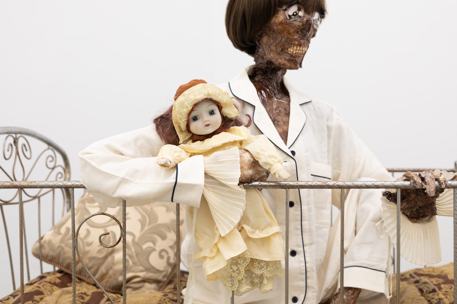 Julien Ceccaldi, Growing up Gay, 2026, Crib, comforter, plastic skeleton, melted drop cloth, wood stain, wig, acrylic paint on duralar, fake eyelashes, pyjama, and video game controller, courtesy of COOPER COLE